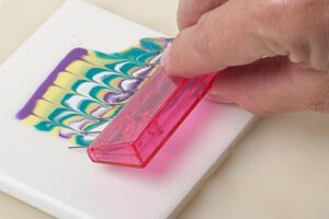 A comb being dragged through colored polyclay